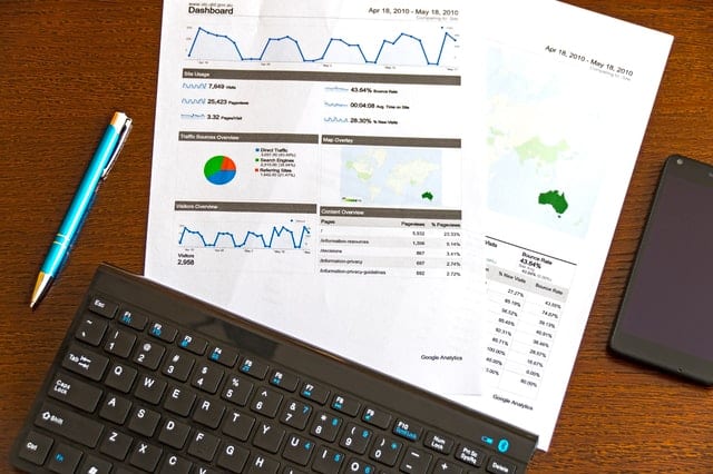 printed metrics next to computer keyboard